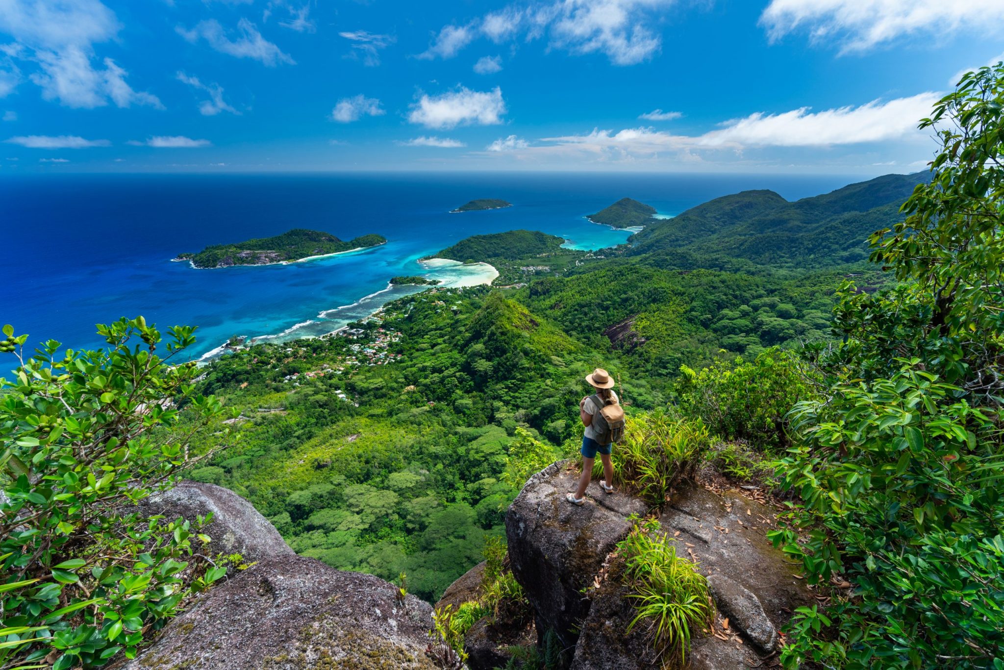 woman high above on tropical island mountain